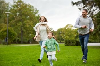 family, parenthood, leisure and people concept - happy mother, father and little girl running and playing catch game in summer park