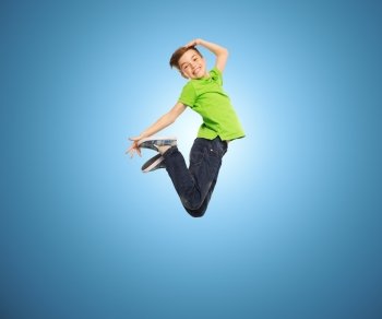 happiness, childhood, freedom, movement and people concept - smiling boy jumping in air over blue background