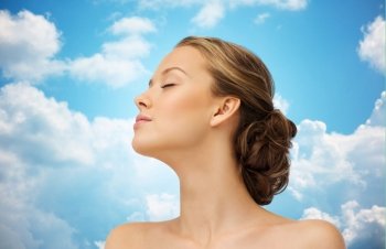 beauty, people and health concept - young woman face with closed eyes and shoulders side view over blue sky and clouds background