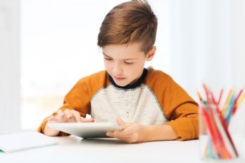 leisure, children, technology and people concept - close up of boy with tablet pc computer at home