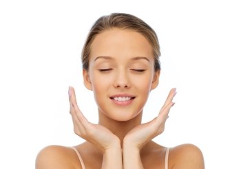 beauty, people, skincare and health concept - smiling young woman face and hands