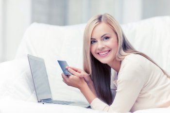 smiling businesswoman with laptop and credit card. businesswoman with laptop and credit card