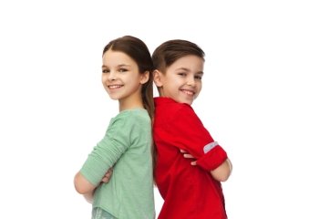 childhood, fashion and people concept - happy smiling boy and girl standing back to back