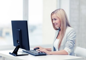 picture of smiling businesswoman using her computer. businesswoman with computer
