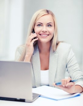 business and education concept - picture of businesswoman with laptop and cell phone. businesswoman with laptop and cell phone