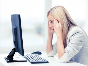 business, office, school and education concept - stressed businesswoman with computer at work