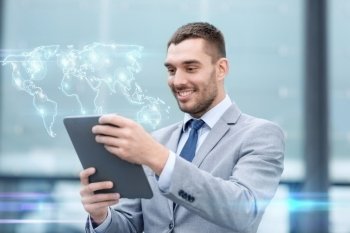 global business, education, technology and people concept - smiling businessman working with tablet pc computer and world map hologram on city street