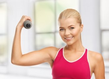picture of young sporty woman with light dumbbell
