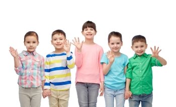childhood, fashion, friendship and people concept - group of happy smiling little children holding hands