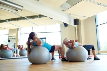 fitness, sport, exercising and lifestyle concept - group of women with exercise balls in gym