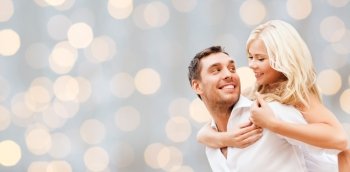romance, people, love and dating concept - happy couple over holidays lights background