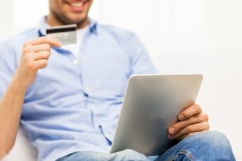 technology, people, online shopping, banking and lifestyle concept - close up of man with tablet pc computer and credit or bank card at home