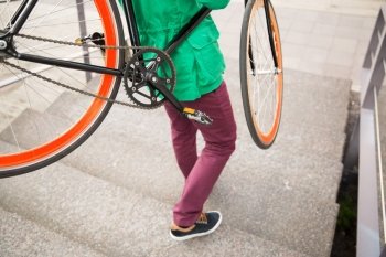 people, style, leisure and lifestyle - close up of man with fixed gear bike going downstairs