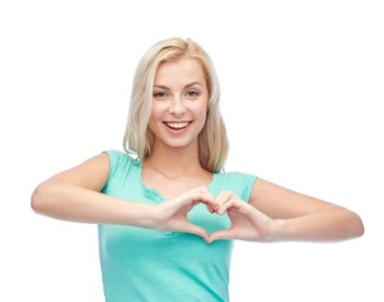 gesture and people concept - smiling young woman or teenage girl showing heart shape made of fingers. happy woman or teen girl showing heart shape sigh