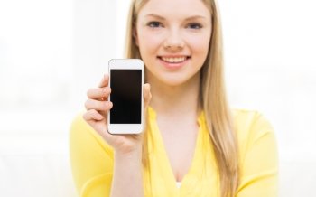 people, technology and advertisement concept - close up of young woman showing smartphone blank screen at home