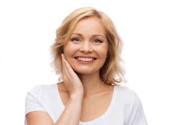 beauty, people and skincare concept - smiling woman in white shirt touching face