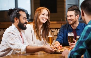 leisure, food and drinks, people and holidays concept - smiling friends eating pizza and drinking beer at pizzeria or pub