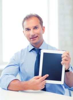 picture of smiling businessman with tablet pc in office. smiling businessman with tablet pc in office