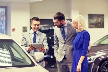 auto business, car sale, technology and people concept - happy couple with car dealer in auto show or salon