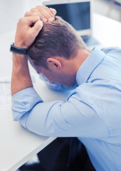 business, office, school and education concept - stressed businessman with papers at work