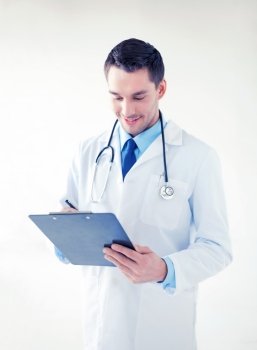 bright picture of male doctor writing prescription. male doctor writing prescription