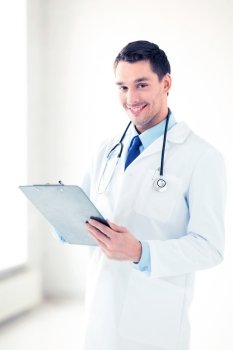 bright picture of male doctor writing prescription. male doctor writing prescription