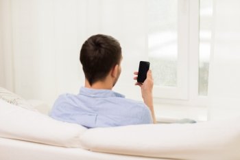 people, technology, communication and internet concept - close up of man with smartphone at home
