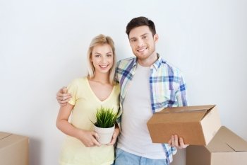 home, people, repair and real estate concept - smiling couple with big cardboard boxes moving to new place
