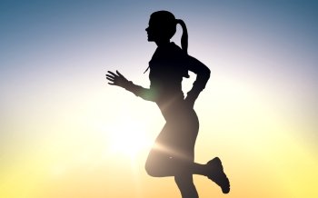 fitness, sport, people and healthy lifestyle concept - happy young sports woman running outdoors