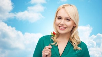 healthy eating, food, diet and people concept - smiling young woman eating vegetable salad with fork over blue sky and clouds background