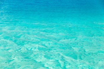 travel, tourism, vacation and summer holidays concept - sea or ocean blue transparent water