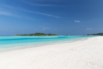 travel, tourism, vacation and summer holidays concept - maldives island beach with palm tree and villa