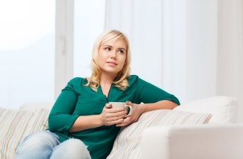 people and leisure concept - happy woman  with cup of tea or coffee at home. happy woman  with cup of tea or coffee at home