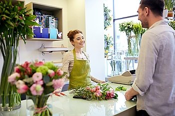people, shopping, sale, floristry and consumerism concept - happy smiling florist woman and man or customer talking at flower shop