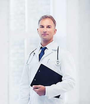 healthcare and medical concept - male doctor with stethoscope and clipboard. male doctor with stethoscope and notes