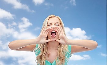 emotions, expressions and people concept - angry young woman or teenage girl shouting over blue sky and clouds background