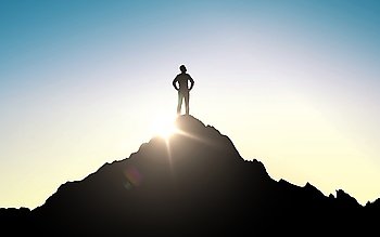 business, success, leadership, achievement and people concept - silhouette of businessman on mountain top over sky and sun light background