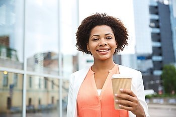business, drinks and people concept - young smiling african american businesswoman with coffee cup in city