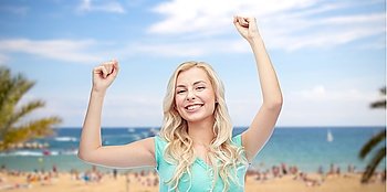emotions, expressions, summer holidays, travel and people concept - happy young woman or teenage girl celebrating victory over exotic tropical beach with palm trees and sea background