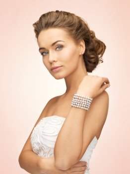 beautiful bride wearing pearl earrings and bracelet