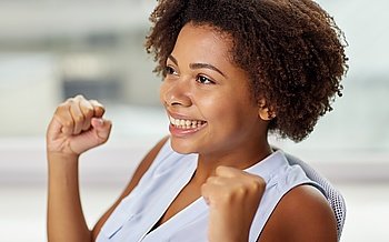 people, emotions, gesture and success concept - happy african american young woman with raised fists
