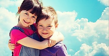 summer, childhood, family, friendship and people concept - two happy kids hugging over blue sky with clouds background