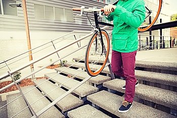 people, style, leisure and lifestyle - close up of man with fixed gear bike going downstairs
