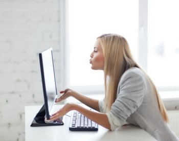 picture of happy woman kissing computer monitor