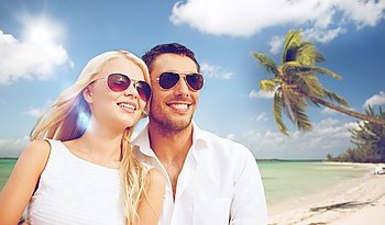 summer holidays and dating concept - happy couple in sunglasses at maldives beach. happy couple in sunglasses at maldives beach