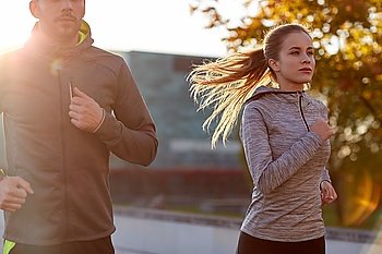 fitness, sport, people and lifestyle concept - couple running outdoors