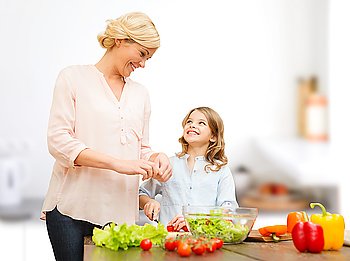 vegetarian food, culinary, family and people concept - happy mother and daughter cooking vegetable salad for dinner and talking over home kitchen background