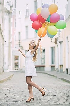 summer holidays, celebration and lifestyle concept - beautiful woman with colorful balloons in the city