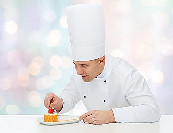 cooking, profession, haute cuisine, food and people concept - happy male chef cook decorating dessert over blue lights background