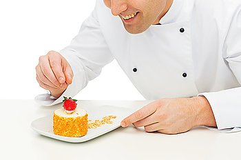 cooking, profession, haute cuisine, food and people concept - close up of happy male chef cook decorating dessert